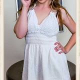 Gracie May Green standing in a white dress